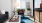 a living room with a blue rug and ample seating