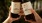 a couple of hands holding bottles of alcohol