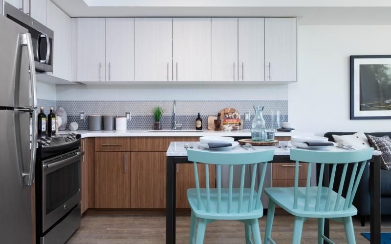 a modern kitchen with a table and chairs