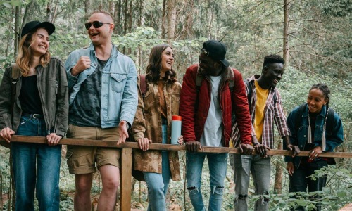 a group of people standing on a bridge over a river