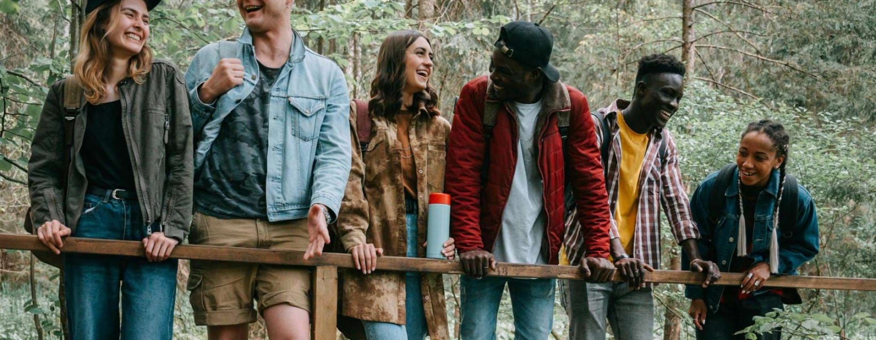 a group of people standing on a bridge over a river
